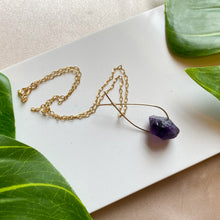 Load image into Gallery viewer, A deep violet-colored natural rough Amethyst gemstone set on a 14K gold-fill pendant and strung along a dainty paper clip cable chain, then finished with a vintage-inspired pearl box clasp. Amethyst is the birthstone for those born in the month of February (Aquarius/Pisces) and the stone for commemorating 6th wedding anniversaries! 
