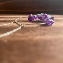 Cargar imagen en el visor de la galería, This beautiful cluster of natural rough Amethyst stones are set on a sterling silver half-circle, hung from a dainty sterling silver satellite curb chain, and finished with a vintage-inspired pearl box clasp.
