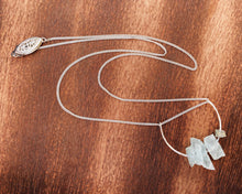 Load image into Gallery viewer, This beautiful cluster of natural rough Aquamarine stones are set on a sterling silver half-circle, hung from a dainty sterling silver curb chain, and finished with a vintage-inspired pearl box clasp.
