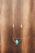 Load image into Gallery viewer, This beautiful natural mined rough Aquamarine stone is set on a sterling silver half-circle, hung from a dainty sterling silver rectangular paperclip cable chain, adorned with Freshwater Pearls (six in total), and finished with a vintage-inspired pearl box clasp.
