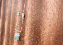 Load image into Gallery viewer, This beautiful natural mined rough Aquamarine stone is set on a sterling silver half-circle, hung from a dainty sterling silver rectangular paperclip cable chain, adorned with Freshwater Pearls (six in total), and finished with a vintage-inspired pearl box clasp.
