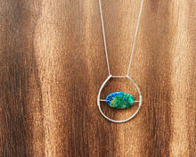 Cargar imagen en el visor de la galería, This stunning natural, mined Azurite-Malachite-Chrysocolla Pendant is 9.25 carats and has been polished into an oval cabochon and suspended upon sterling silver wire amid a sterling silver horseshoe shaped ring pendant, which hangs upon a smooth, dainty sterling silver curb chain.
