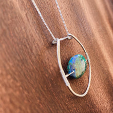 Cargar imagen en el visor de la galería, This stunning natural, mined Azurite-Malachite-Chrysocolla Pendant is 9.25 carats and has been polished into an oval cabochon and suspended upon sterling silver wire amid a sterling silver horseshoe shaped ring pendant, which hangs upon a smooth, dainty sterling silver curb chain.
