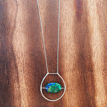 Cargar imagen en el visor de la galería, This stunning natural, mined Azurite-Malachite-Chrysocolla Pendant is 9.25 carats and has been polished into an oval cabochon and suspended upon sterling silver wire amid a sterling silver horseshoe shaped ring pendant, which hangs upon a smooth, dainty sterling silver curb chain.
