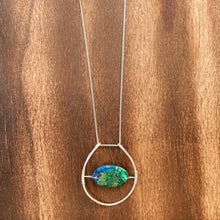 Load image into Gallery viewer, This stunning natural, mined Azurite-Malachite-Chrysocolla Pendant is 9.25 carats and has been polished into an oval cabochon and suspended upon sterling silver wire amid a sterling silver horseshoe shaped ring pendant, which hangs upon a smooth, dainty sterling silver curb chain.
