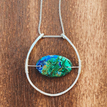 Load image into Gallery viewer, This stunning natural, mined Azurite-Malachite-Chrysocolla Pendant is 9.25 carats and has been polished into an oval cabochon and suspended upon sterling silver wire amid a sterling silver horseshoe shaped ring pendant, which hangs upon a smooth, dainty sterling silver curb chain.
