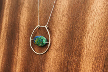 Load image into Gallery viewer, This stunning natural, mined Azurite-Malachite-Chrysocolla Pendant is 9.25 carats and has been polished into an oval cabochon and suspended upon sterling silver wire amid a sterling silver horseshoe shaped ring pendant, which hangs upon a smooth, dainty sterling silver curb chain.
