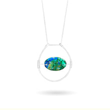 Cargar imagen en el visor de la galería, This stunning natural, mined Azurite-Malachite-Chrysocolla Pendant is 9.25 carats and has been polished into an oval cabochon and suspended upon sterling silver wire amid a sterling silver horseshoe shaped ring pendant, which hangs upon a smooth, dainty sterling silver curb chain.
