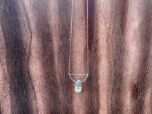 Load image into Gallery viewer, This stunning natural Black Moonstone gemstone has colors of slate grey and tan with a velvety silver flash across the surface when it is moved about in the light. This naturally-shaped Black Moonstone is set on a sterling silver half-circle, hung from a dainty sterling silver paper clip cable chain, and finished with a vintage-inspired pearl box clasp. The perfect necklace for those looking for a minimal design, but still want a unique gemstone rarely seen in most jewelry collections.
