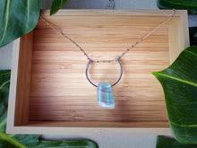 Cargar imagen en el visor de la galería, A colorful polished Fluorite stone is set on a hammered sterling silver semicircle with wire detail and strung on a sterling silver satellite curb chain, then finished with a vintage-inspired pearl box clasp. The sizable Fluorite stone has stunning colors of green and purple, and coupled with the satellite chain, it brings just enough sparkle to any ensemble. 
