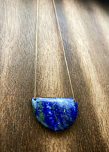 Load image into Gallery viewer, Lapis Lazuli is known as the stone of friendship and a crystal of truth. This natural lapis lazuli gemstone is deep blue in color with striking reflective gold flakes throughout. It is strung onto a dainty 14K GF chain and finished with a vintage-inspired pearl box clasp. 
