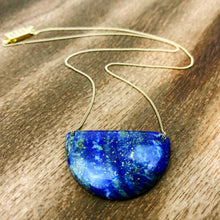 Load image into Gallery viewer, Lapis Lazuli is known as the stone of friendship and a crystal of truth. This natural lapis lazuli gemstone is deep blue in color with striking reflective gold flakes throughout. It is strung onto a dainty 14K GF chain and finished with a vintage-inspired pearl box clasp. 
