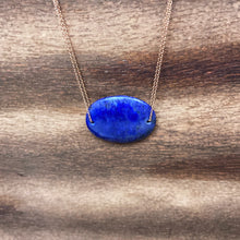 Load image into Gallery viewer, Lapis Lazuli is known as the stone of friendship and a crystal of truth. This natural Lapis Lazuli gemstone is polished into an oval cabochon and strung on a dainty 14K gold-fill rose gold cable chain, which has been doubled up on both sides, and completed with a vintage-inspired pearl box clasp.
