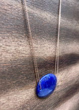 Load image into Gallery viewer, Lapis Lazuli is known as the stone of friendship and a crystal of truth. This natural Lapis Lazuli gemstone is polished into an oval cabochon and strung on a dainty 14K gold-fill rose gold cable chain, which has been doubled up on both sides, and completed with a vintage-inspired pearl box clasp.
