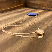 Load image into Gallery viewer, Lapis Lazuli is known as the stone of friendship and a crystal of truth. This natural Lapis Lazuli gemstone is polished into an oval cabochon and strung on a dainty 14K gold-fill rose gold cable chain, which has been doubled up on both sides, and completed with a vintage-inspired pearl box clasp.
