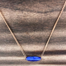 Load image into Gallery viewer, Lapis Lazuli is known as the stone of friendship and a crystal of truth. This natural Lapis Lazuli gemstone is polished into an oval cabochon and strung on a dainty 14K gold-fill rose gold cable chain, which has been doubled up on both sides, and completed with a vintage-inspired pearl box clasp.
