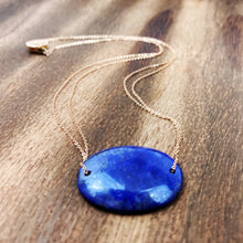 Load image into Gallery viewer, Lapis Lazuli is known as the stone of friendship and a crystal of truth. This natural Lapis Lazuli gemstone is polished into an oval cabochon and strung on a dainty 14K gold-fill rose gold cable chain, which has been doubled up on both sides, and completed with a vintage-inspired pearl box clasp.
