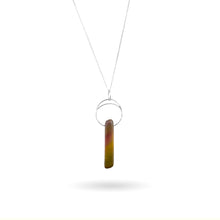 Load image into Gallery viewer, This natural Mookaite gemstone has been polished into a long rectangular shape and hung from a hammered sterling silver circle/half moon pendant and strung on a sterling silver curb chain. This stone is uniquely attractive with plenty of color including pink, green, yellow, mauve, red, and gray.
