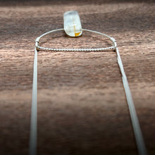 Load image into Gallery viewer, This silky natural Moonstone gemstone has an almost magical pearly iridescence. This Moonstone is from the mines of North Carolina and is supported by a hammered sterling silver half moon pendant and strung along a dainty sterling silver curb chain then finished with a vintage-inspired pearl box clasp.
