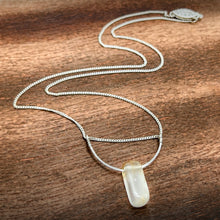 Cargar imagen en el visor de la galería, This silky natural Moonstone gemstone has an almost magical pearly iridescence. This Moonstone is from the mines of North Carolina and is supported by a hammered sterling silver half moon pendant and strung along a dainty sterling silver curb chain then finished with a vintage-inspired pearl box clasp.
