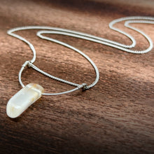 Cargar imagen en el visor de la galería, This silky natural Moonstone gemstone has an almost magical pearly iridescence. This Moonstone is from the mines of North Carolina and is supported by a hammered sterling silver half moon pendant and strung along a dainty sterling silver curb chain then finished with a vintage-inspired pearl box clasp.
