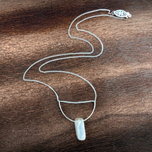 Load image into Gallery viewer, This silky natural Moonstone gemstone has an almost magical pearly iridescence. This Moonstone is from the mines of North Carolina and is supported by a hammered sterling silver half moon pendant and strung along a dainty sterling silver curb chain then finished with a vintage-inspired pearl box clasp.
