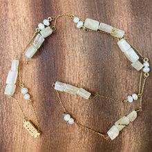 Load image into Gallery viewer, A long 14K gold-fill chain has earthy Rutilated Quartz gemstones and Freshwater Pearls strung throughout and finished with a vintage-inspired pearl box clasp. The perfect chain for wearing on its own or along with other chains as a part of a stack. This piece is both sophisticated and understated, yet the closer you look at it, the more interesting it becomes. 
