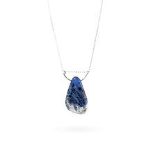 Load image into Gallery viewer, This large royal blue Sodalite gemstone pendant makes a statement with its “weathered blue jean” look. The oblong stone is suspended by a hammered sterling silver half-moon pendant and strung along a long sterling silver curb chain, and finished with a vintage-inspired pearl box clasp. A
